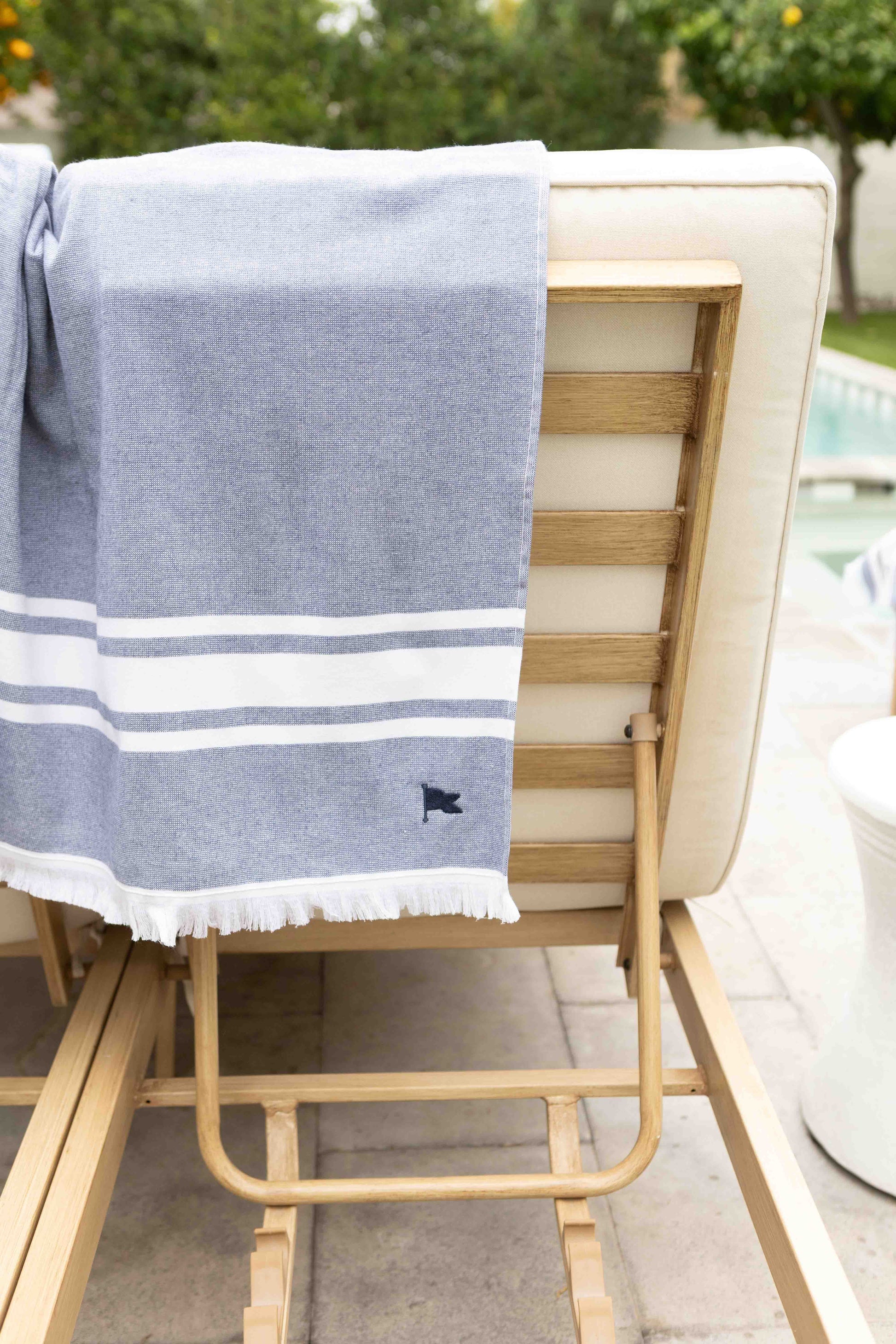 Blue towel with white triple stripe. Amalfi beach towel by Banner Beach for home pool.